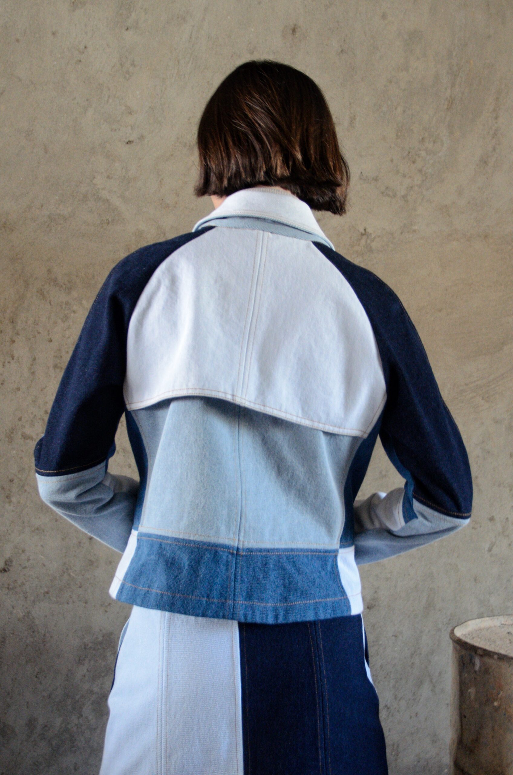 Doria jacket in blue patchwork denim back view with trench-inspired yoke