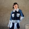 Doria jacket in blue patchwork denim front view with contrast paneling