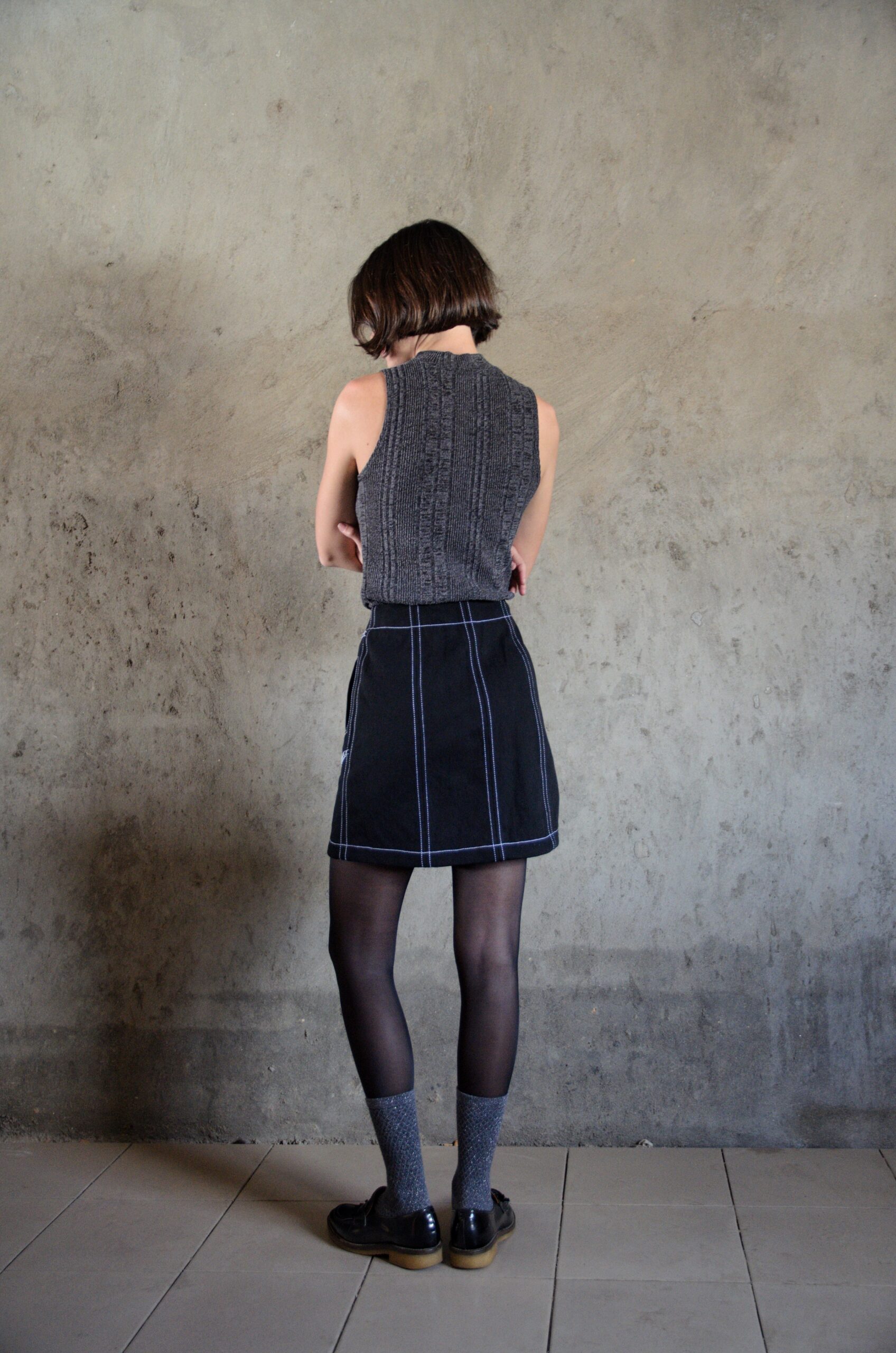 Tantely skirt in black denim back view with contrast stitching