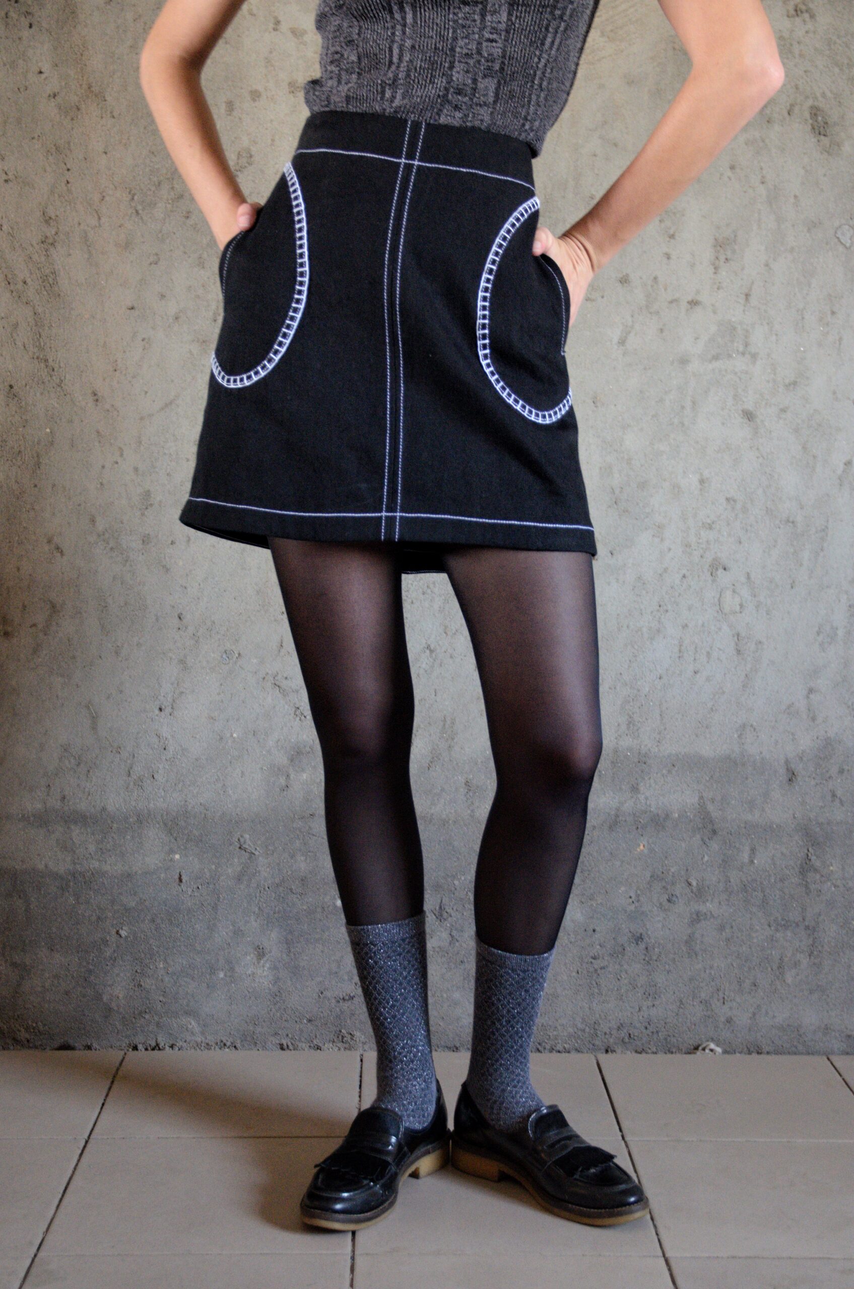 Tantely skirt in black denim front view with contrast stitching and crochet details